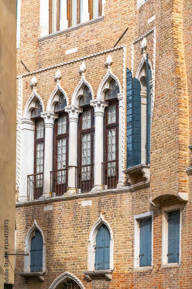 Obraz premium facade with traditional Venetian windows an old house in Venice