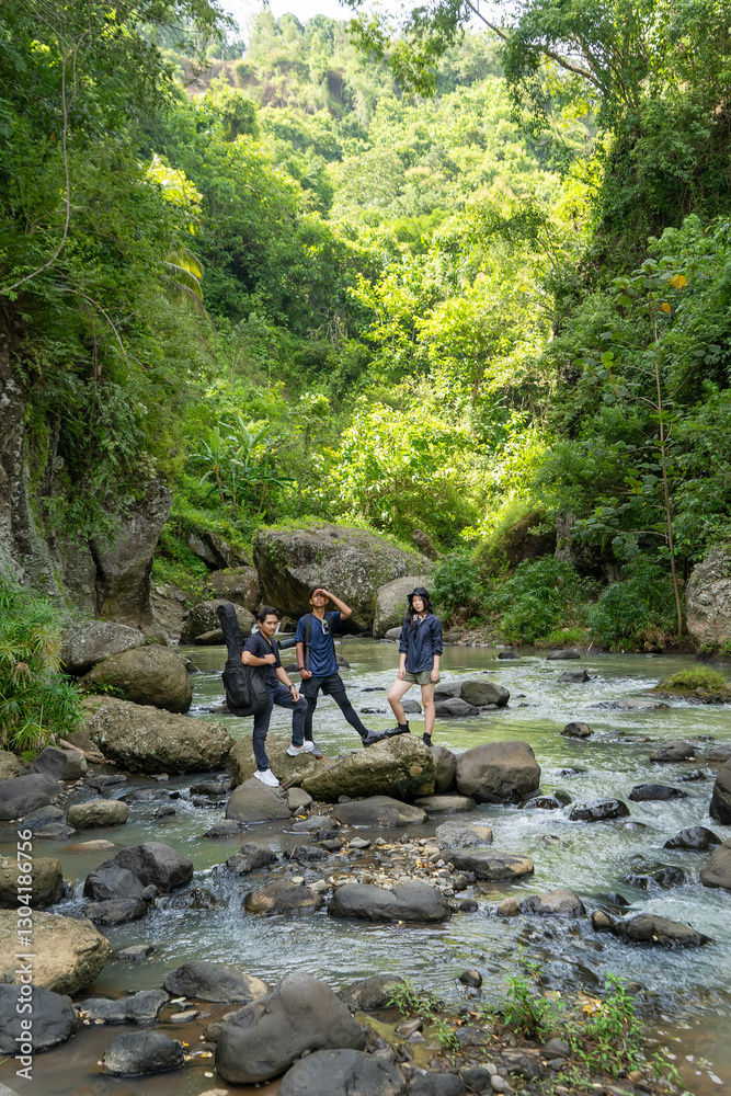 group of young asian standing on the rock while hiking and trekking in tropical nature group of young asian standing on the rock while hiking and trekking in tropical nature