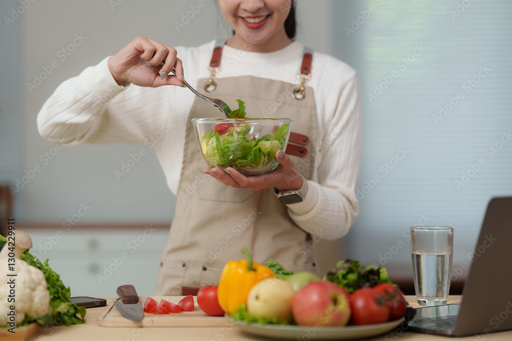 Smiling food blogger preparing healthy salad in her kitchen Smiling food blogger preparing healthy salad in her kitchen