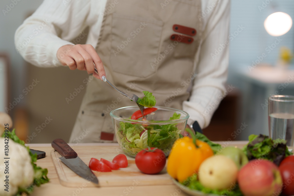 Chef preparing healthy salad with fresh vegetables in modern kitchen Chef preparing healthy salad with fresh vegetables in modern kitchen