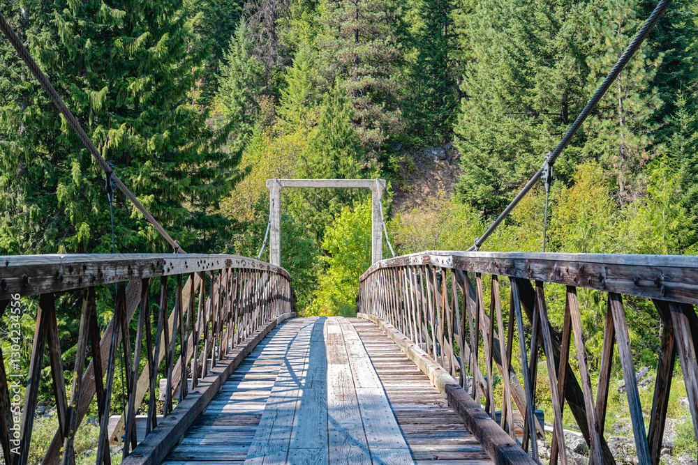 An old wood suspension bridges crosses the Lochsa River on the Eagle Mountain Trail near Powell Junction, Idaho, USA An old wood suspension bridges crosses the Lochsa River on the Eagle Mountain Trail near Powell Junction, Idaho, USA