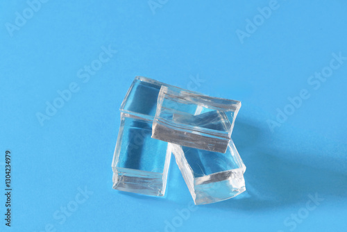Clear ice cubes over a blue background