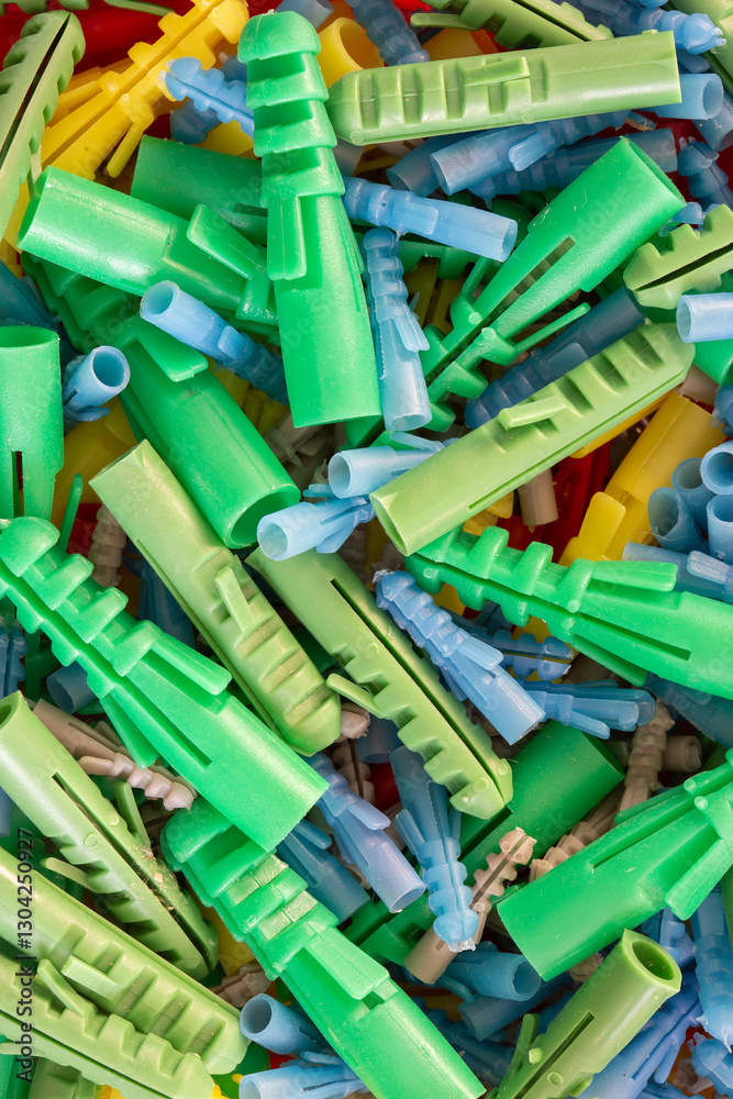 Pile of assorted sizes wall plugs background backdrop. Construction do it yourself fixings concept.