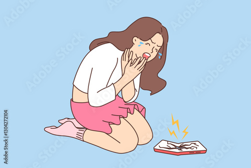 Woman broke phone and cries on knees because of gadget with cracks on screen in need of replacement