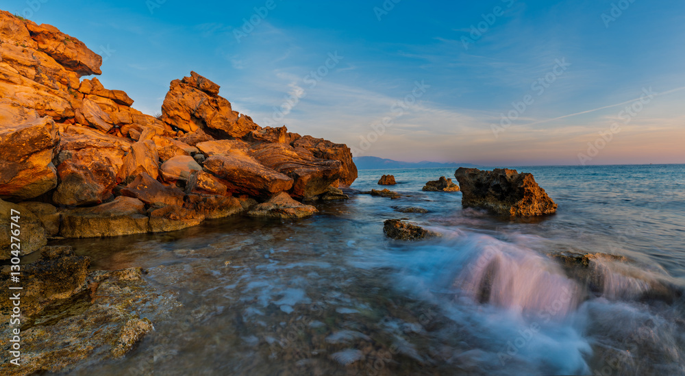 Beautiful sunrise on the wild, rocky bay of Zakynthos island