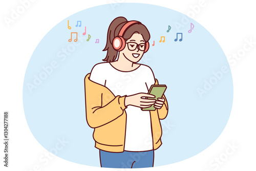 Teenage girl listens music on headphones and holds phone with application to select track from playlist. Young woman meloman uses wireless headphones and smartphone to search for favorite music