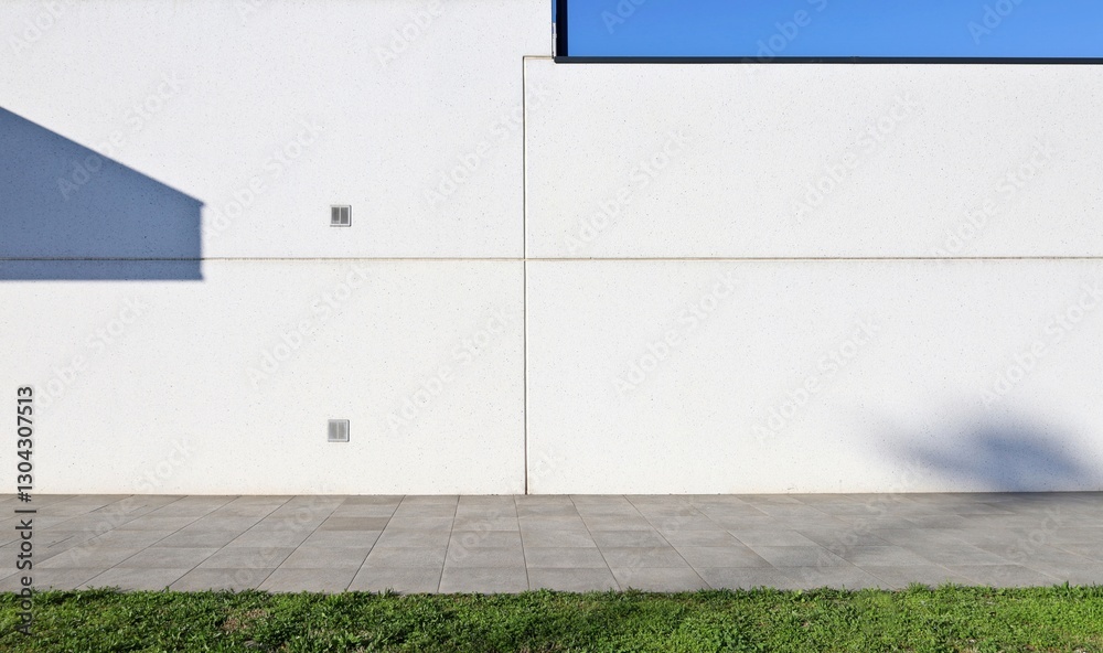 custom made wallpaper toronto digitalWhite concrete prefab wall with stone tiled pavement and a strip of grass in front. Background for copy space