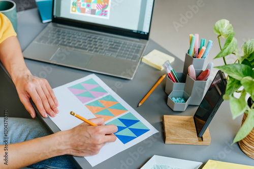 Designer working on graphic design at modern office desk
