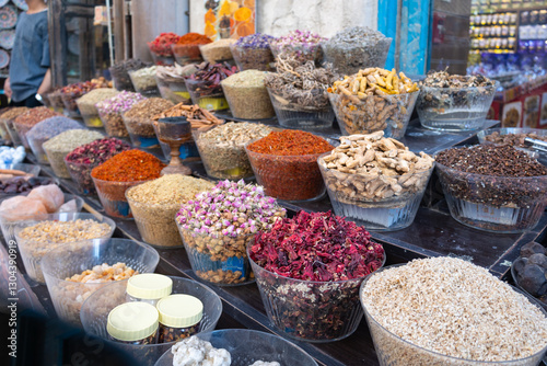 Fototapeta Naklejka Na Ścianę i Meble -  Traditional spices market. Pots and wooden tubs stand in row with colorful tea, spices, fruits, roots, flowers. Street bazaar. Dubai, UAE. 
