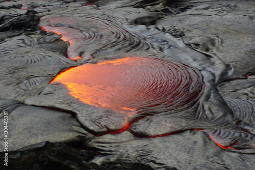 Hot magma flows  over old lava field