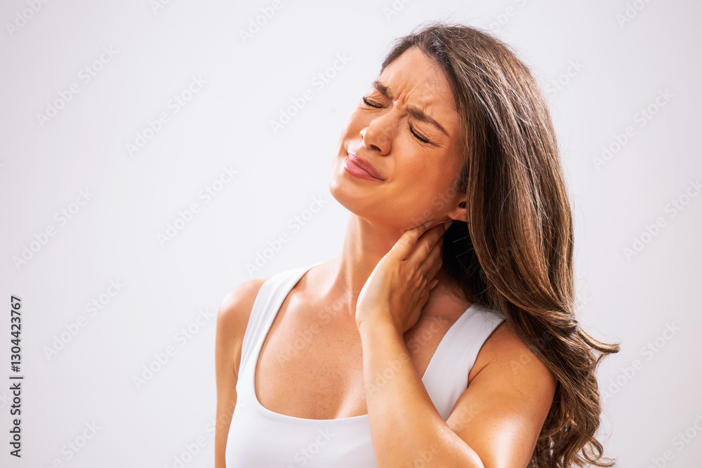 Fototapeta premium Portrait of adult woman who is having sprain in her neck.