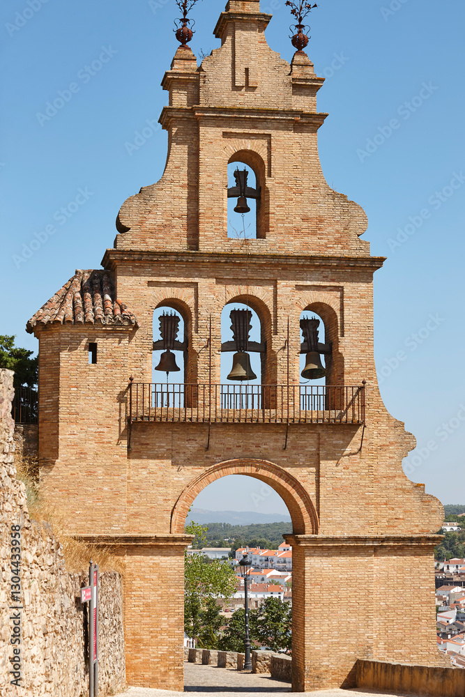 Bell tower castle entrance in andalusian village of Aracena. Spain