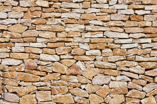 Stone textured wall in brown color. Natural rocky background. Horizontal