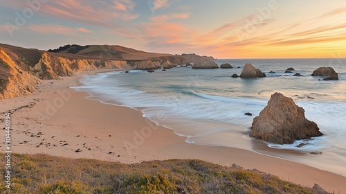 Serene Sunset Over Sandy Beach with Ocean Rocks