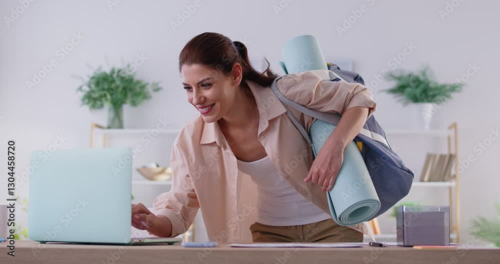 Happy Caucasian woman with a sport bag leaves her home, ready for a training session at the gym. Fitness routine, enthusiasm for working out, and the anticipation of a good workout.