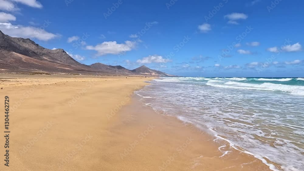 A pristine sandy beach with gentle ocean waves washing ashore, set against a backdrop of rugged mountains. The clear blue sky and the vast coastline create a peaceful and untouched natural landscape. A pristine sandy beach with gentle ocean waves washing ashore, set against a backdrop of rugged mountains. The clear blue sky and the vast coastline create a peaceful and untouched natural landscape.