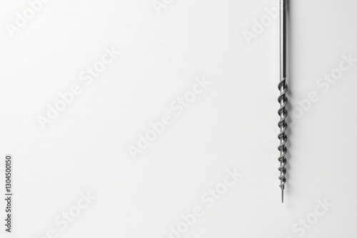 Close-up view of a metallic spiral auger against a plain white backdrop, showcasing its detailed helical structure and sharp point.