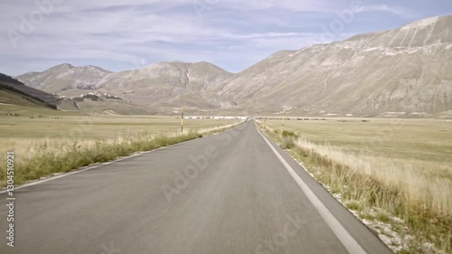 Road In The Middle Of The Valley of Castelluccio di Norcia, Italy