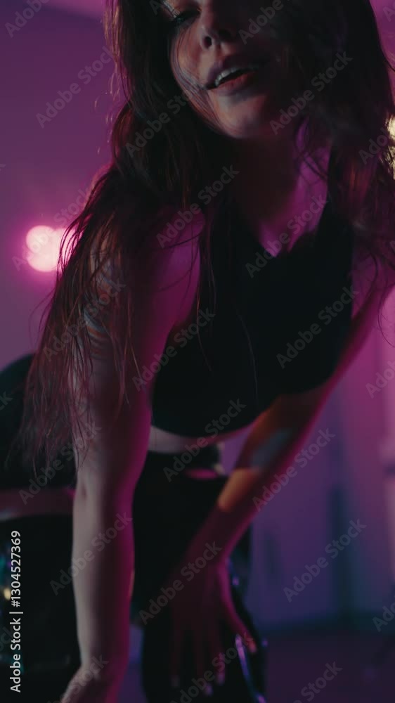A woman dances seductively in a dark room with pink neon lights. She wears high black boots, shorts, and a crop top. She moves with confidence and rhythm. The video exudes sensuality, style, freedom. A woman dances seductively in a dark room with pink neon lights. She wears high black boots, shorts, and a crop top. She moves with confidence and rhythm. The video exudes sensuality, style, freedom.