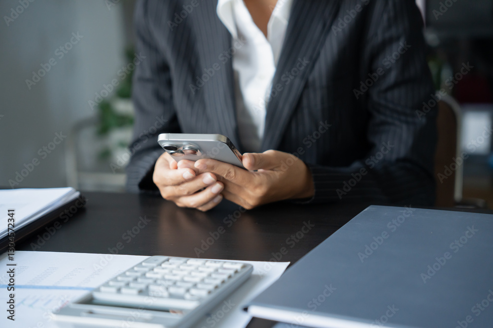 Asian Business woman using smart phone spending time checking news social media Asian Business woman using smart phone spending time checking news social media