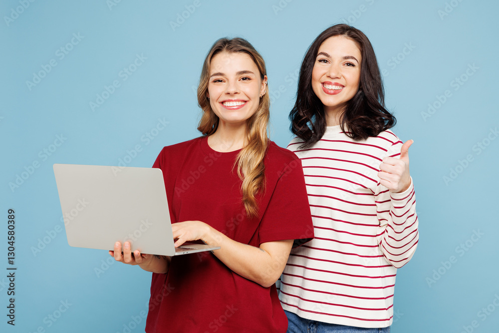 Young IT couple two friends women wearing red casual clothes together hold use work on laptop pc computer showing thumb up isolated on pastel plain light blue cyan background studio Lifestyle concept Young IT couple two friends women wearing red casual clothes together hold use work on laptop pc computer showing thumb up isolated on pastel plain light blue cyan background studio Lifestyle concept