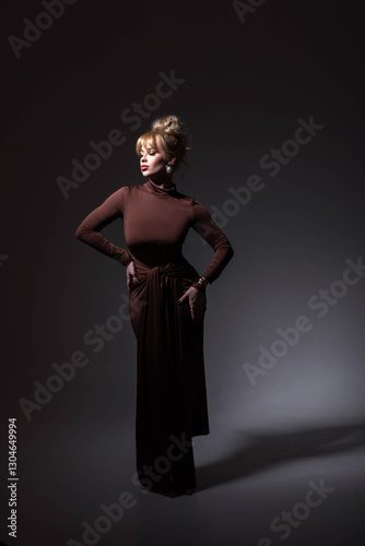 Elegant Woman in a Stylish Brown Dress on a Dark Background