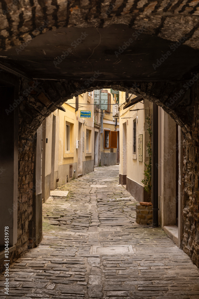 Small gate and winding alleys in picturesque village Piran at Istrian peninsula along the Adriatic sea in Slovenia Small gate and winding alleys in picturesque village Piran at Istrian peninsula along the Adriatic sea in Slovenia