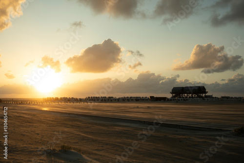 Golden Sunrise Over the North Sea Highlights Coastal Structure and Sandy Beach Landscape at Dawn