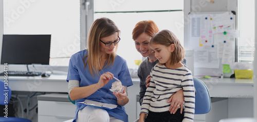 Принти на полотні Girl showing her lost tooth to the dentist during a routine checkup at the dental clinic