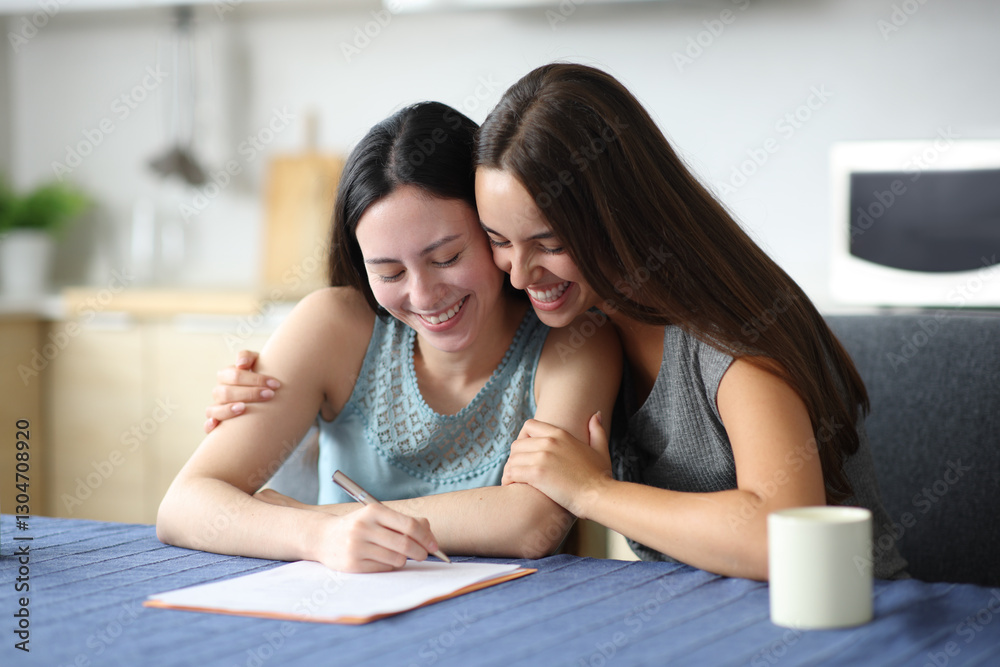 Happy interracial couple hugging and signing contract Happy interracial couple hugging and signing contract