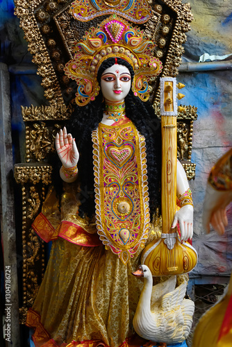 Clay idol of Goddess Saraswati being crafted for Saraswati Puja at a pottery studio in West Bengal, India