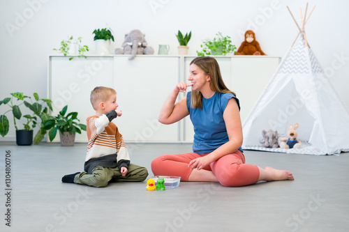 Baby Sign Language. Nonverbal child learning to sign with the help of a speech therapist. Child therapy, neurodiversity, learning difficulty, developmental disability.