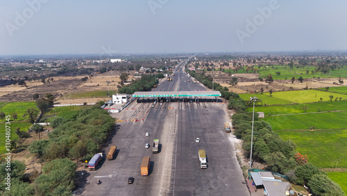 chhattisgarh nh 49 toll gate, highway toll plaza aerial view, Indian national highway traffic, toll booth with vehicles, nh 49 road landscape, highway infrastructure India, toll gate rural backdrop.

 photo