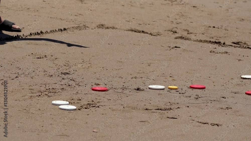 Close up shot of men playing tejo, an Argentinian game famous in summer beach vacations Close up shot of men playing tejo, an Argentinian game famous in summer beach vacations