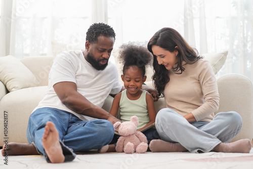 Loving interracial family sitting on floor,playing with kid in living room,bonding african kid with father and mother at home