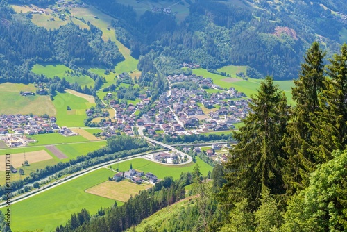 View from above on a valley with a small town. Beautiful mountain landscape of Austria. Mountainous terrain of Austria.