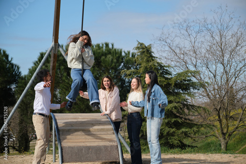 Group of cheerful multi ethnic young adult friends having fun together in a park, enjoying a sunny day outdoors