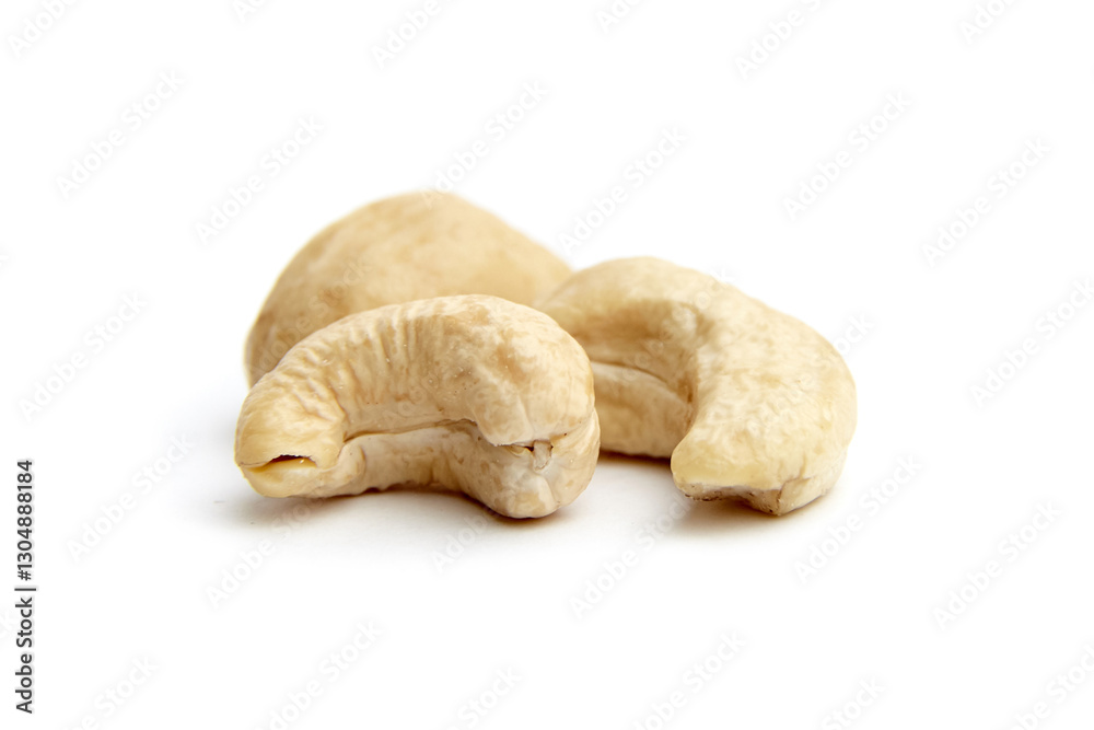 Close-up of three raw cashew nuts arranged on a white surface, showcasing their natural curves and textures. Perfect for healthy eating concepts Close-up of three raw cashew nuts arranged on a white surface, showcasing their natural curves and textures. Perfect for healthy eating concepts