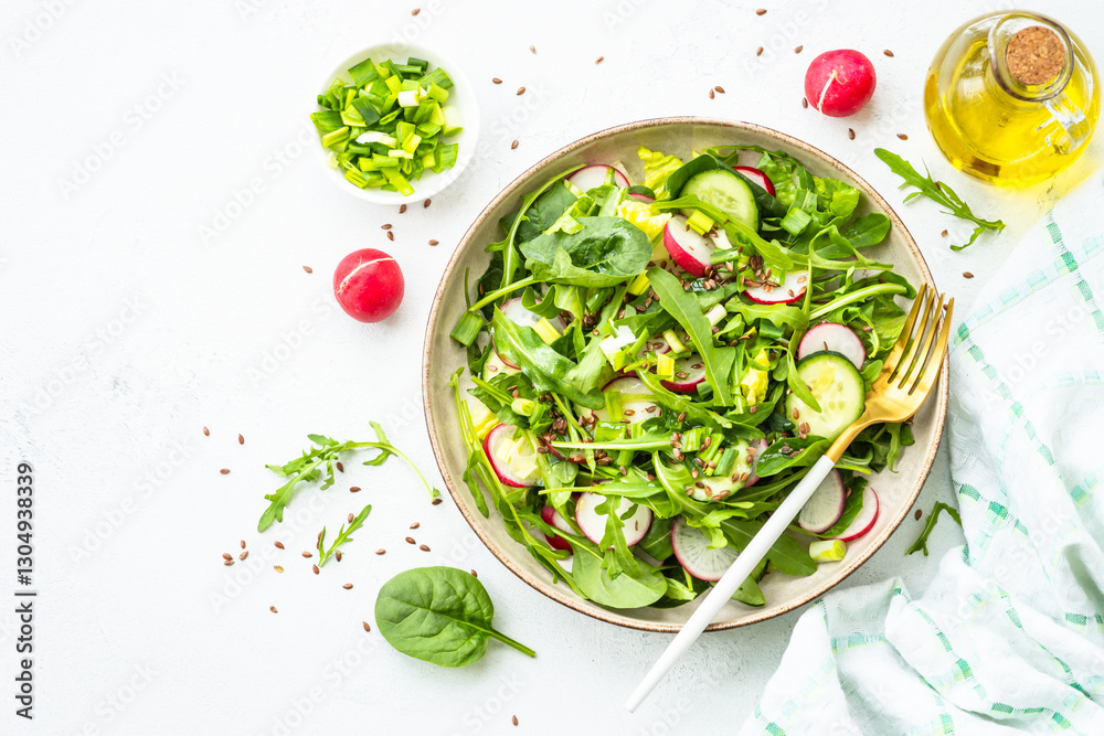 Green salad with spinach, arugula and radish with olive oil.