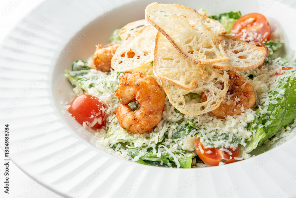 A delicious plate of shrimp salad featuring fresh romaine lettuce, cherry tomatoes, grated cheese, and crispy bread slices, all beautifully arranged and ready to enjoy. A delicious plate of shrimp salad featuring fresh romaine lettuce, cherry tomatoes, grated cheese, and crispy bread slices, all beautifully arranged and ready to enjoy.