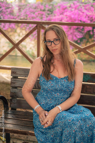 Woman sits on the bench in ...