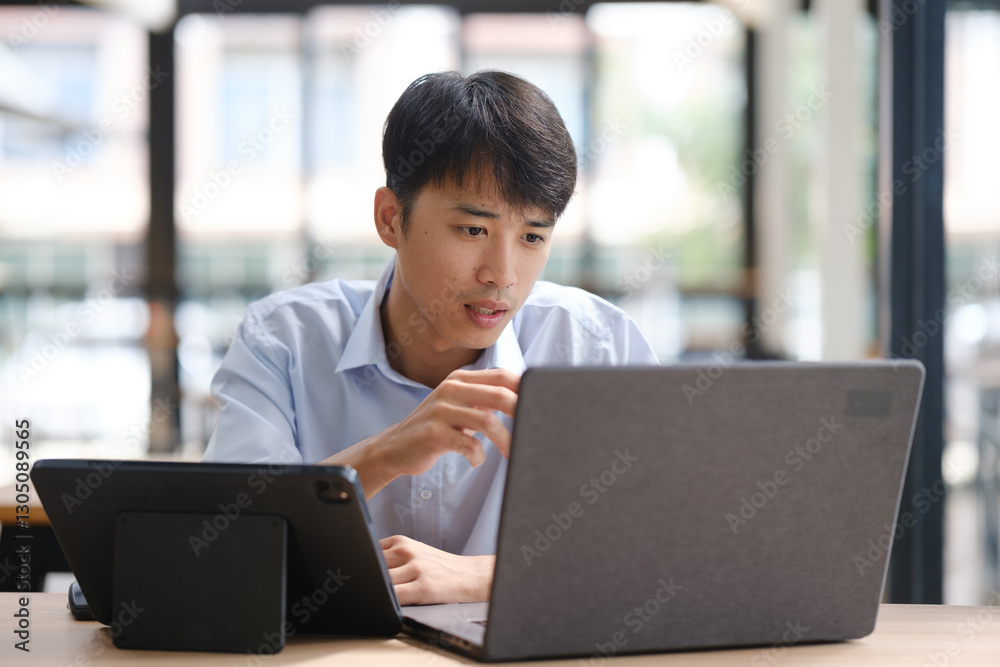 Business consultant analyzing financial data on a laptop Business consultant analyzing financial data on a laptop