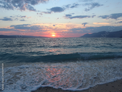 Fototapeta Naklejka Na Ścianę i Meble -  Sunset over the sea with waves, Croatia, Dalmatia