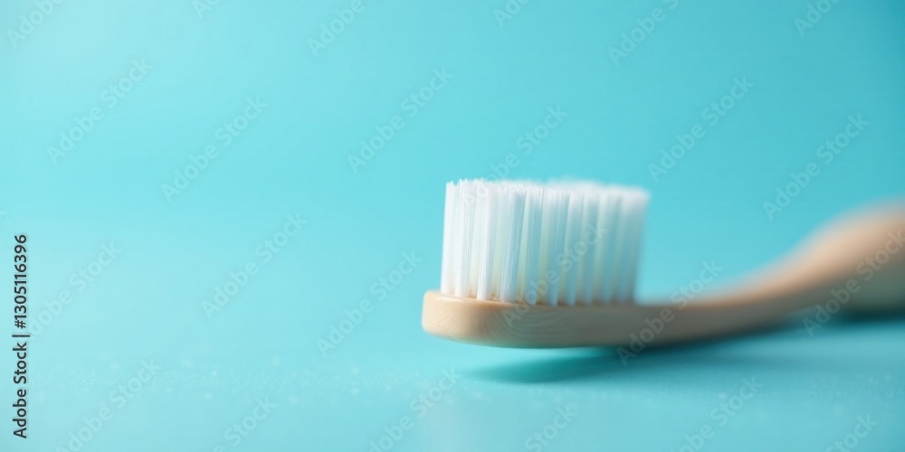 A close-up view of a single toothbrush with soft bristles resting on a vibrant blue surface A close-up view of a single toothbrush with soft bristles resting on a vibrant blue surface