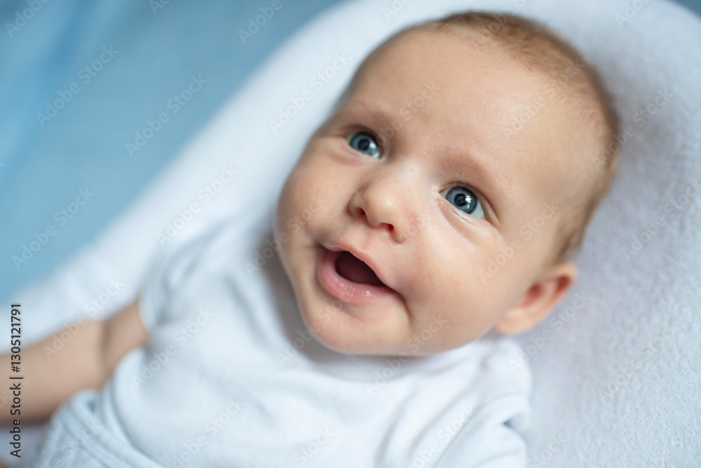 Portrait of baby boy lying in nursery for newborns. Infant in white bed. Baby is 2 months old. Happy baby morning. Portrait of baby boy lying in nursery for newborns. Infant in white bed. Baby is 2 months old. Happy baby morning.