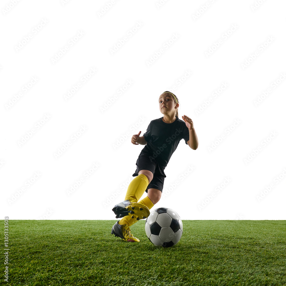 Obraz premium Dynamic image of motivated child, girl in sportswear in motion on field, training, playing soccer against white studio background. Concept of sport, childhood, game, competition, activity