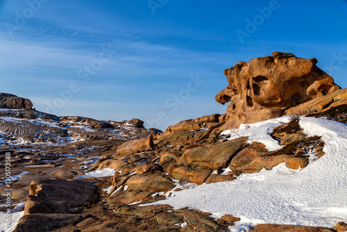 Bektau Ata, Kazakhstan. Spring view with snow and ice on mountains of granite formations with smooth shapes and grooves and geological layers