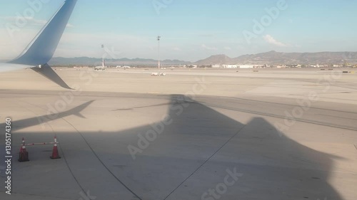 Flying to Las Vegas Airport With a View of the Runway and Mountains