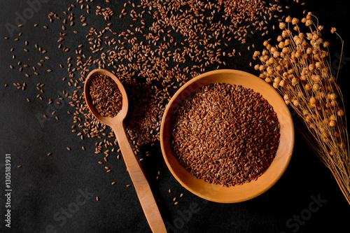 Organic cereals. Healthy eating. Flax seeds in a wooden spoon and plate