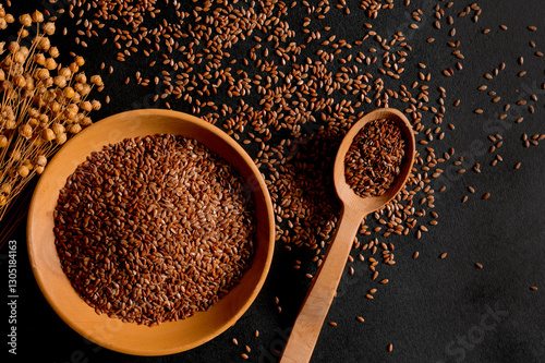 Organic cereals. Healthy eating. Flax seeds in a wooden spoon and plate